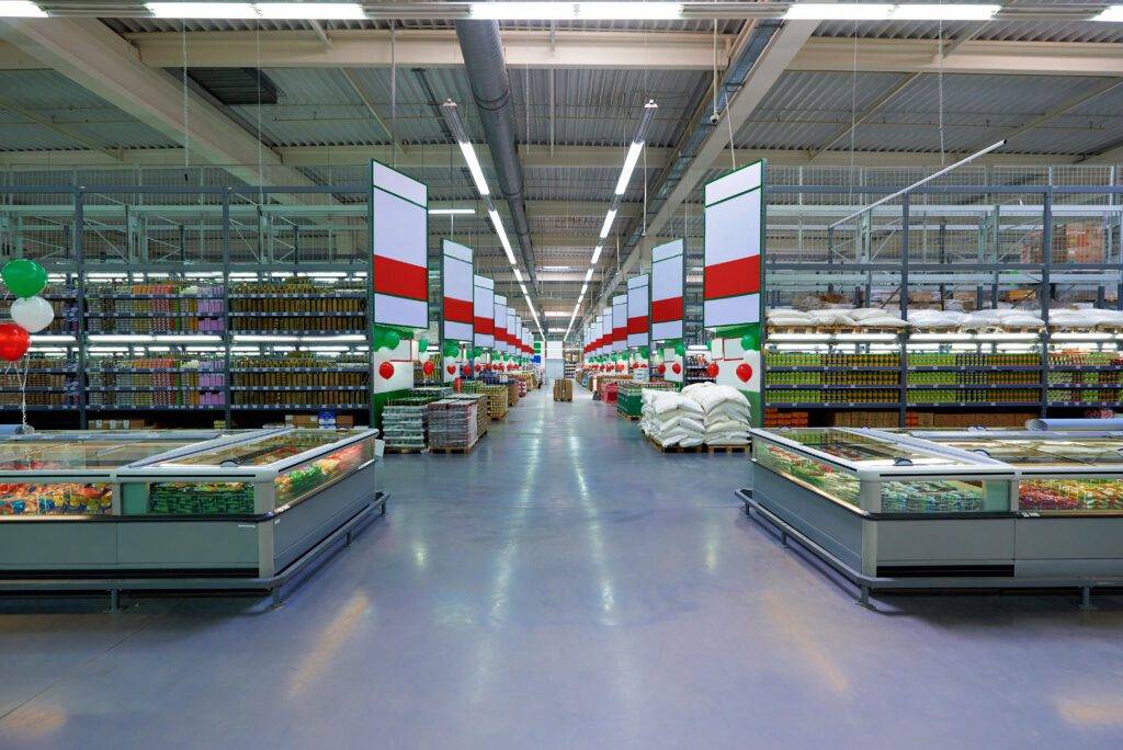 Empty row and grocery shelves in a supermarket.
