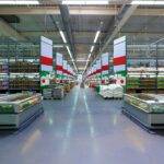 Empty row and grocery shelves in a supermarket.